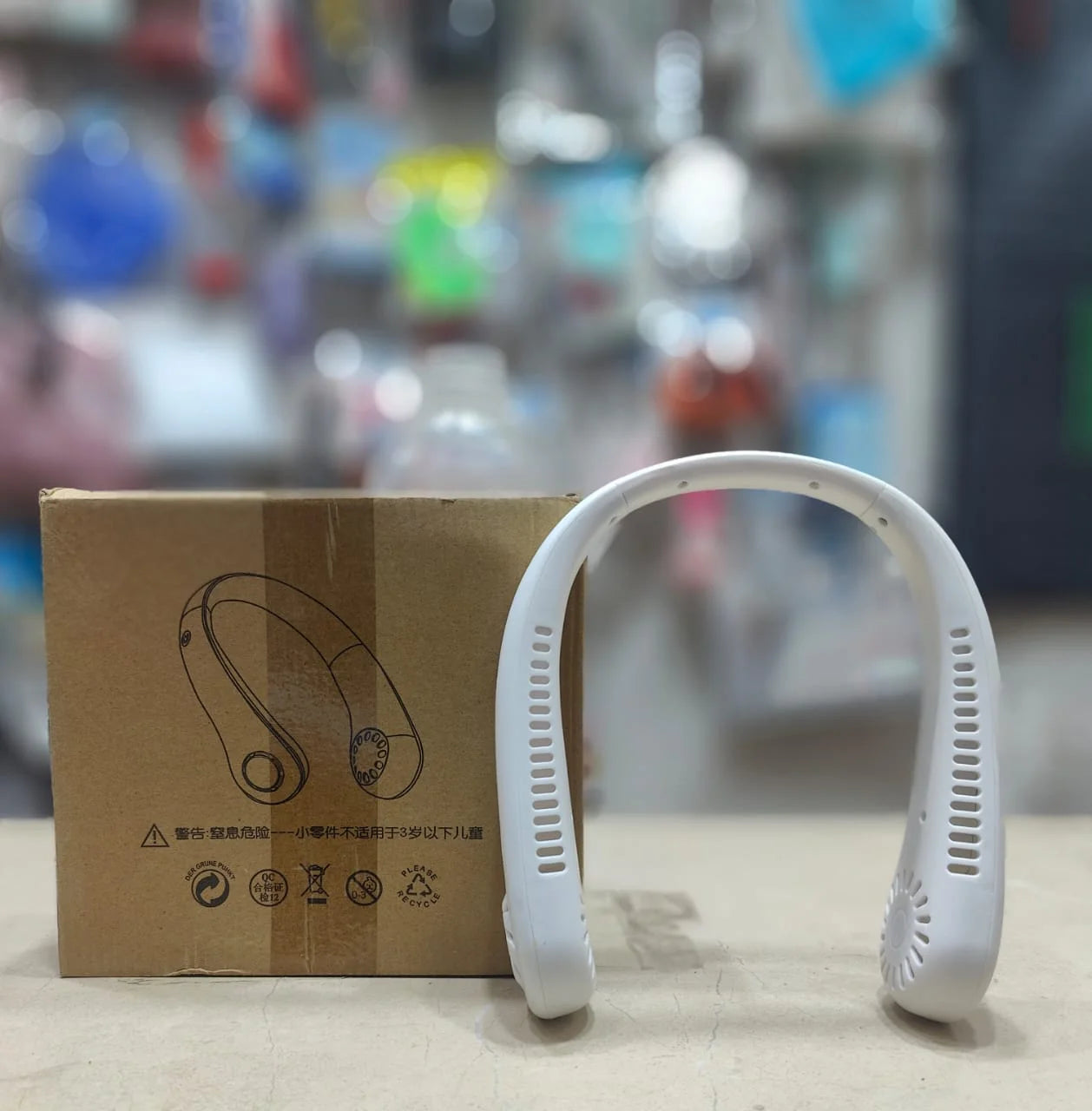 USB rechargeable mini neck fan providing cool air for outdoor use in Pakistan