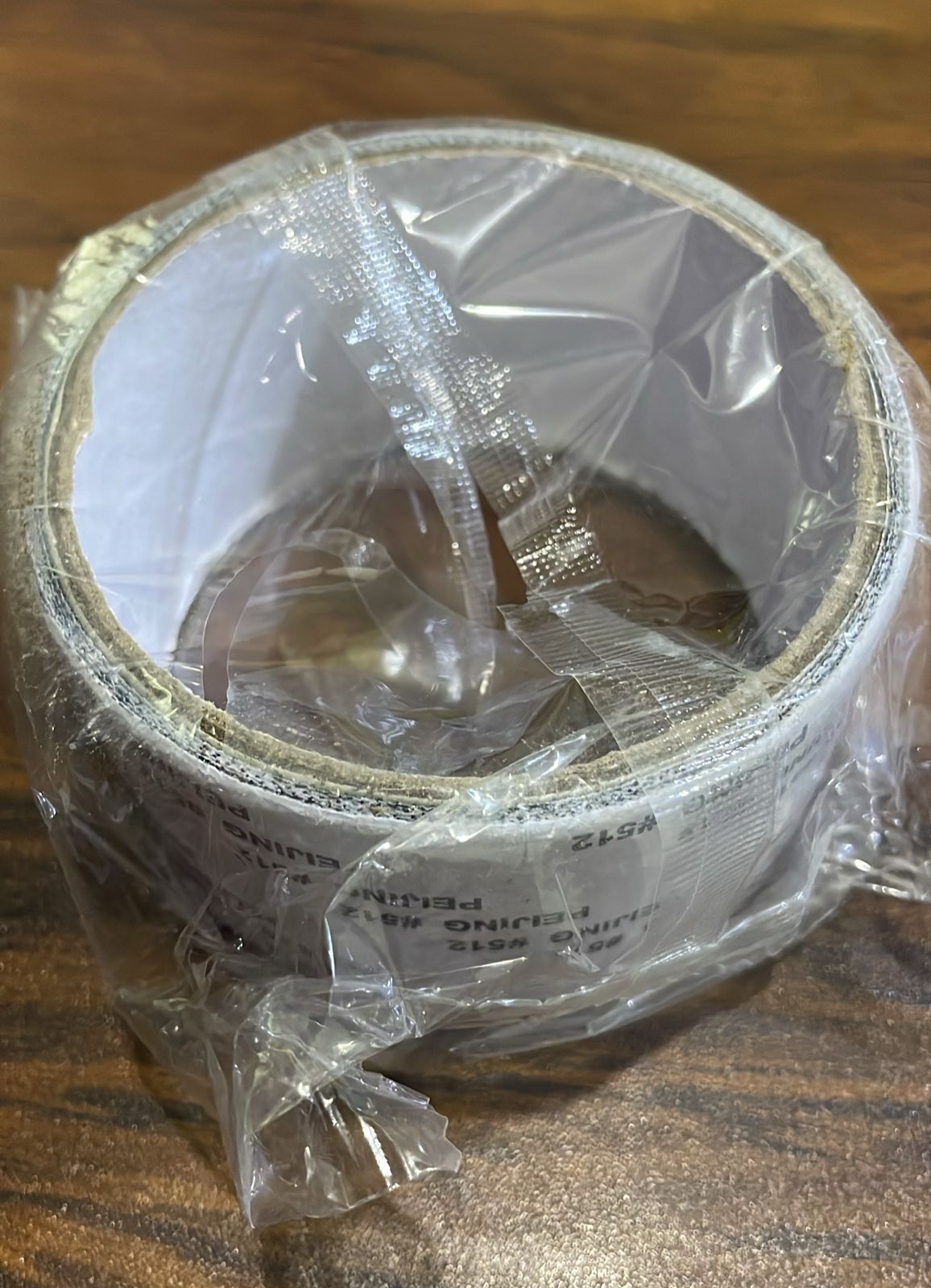 Close up of mesh tape patch covering torn window screen effectively