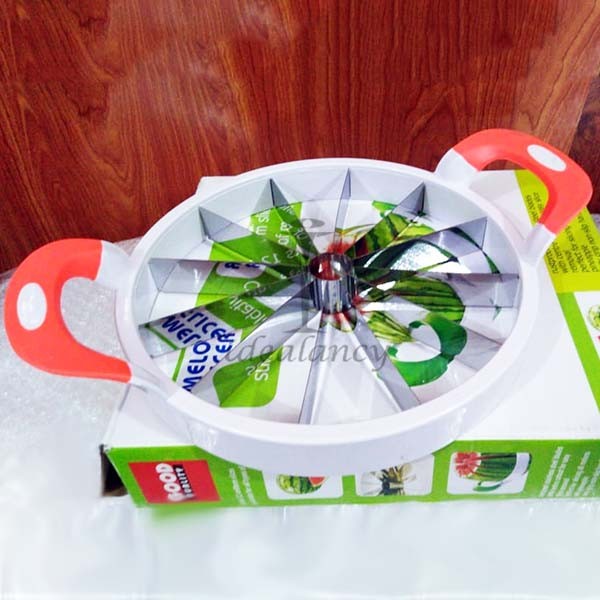 Handheld fruit slicer tool cutting watermelon into perfect slices quickly